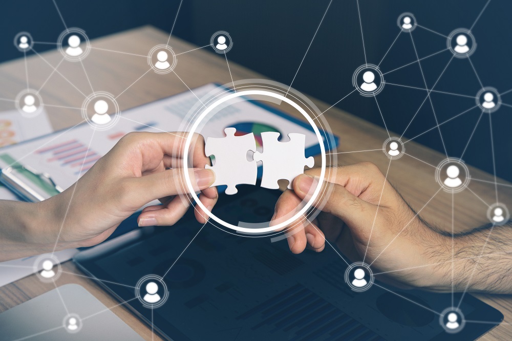 man holding pieces of jigsaw puzzle. business matching concept. crowd sourcing. freelancer. teleworking. Lonehill Systems, a Florida-based SYSPRO ERP Partner